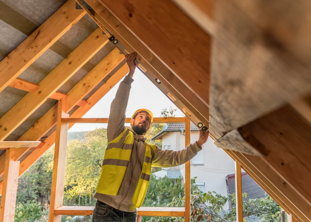 Pro Work Construction Contractor checking roof ceiling alignment